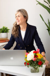 Denver headshots photographer edits photos in her high end studio