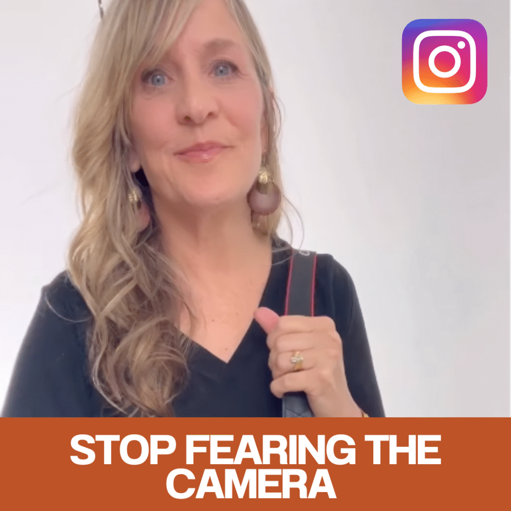 Woman holding a camera mentioning that you don't need to be afraid of photos