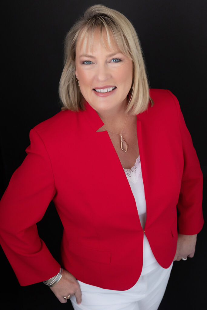 Blonde woman in red jacket leaning into the camera showing how relatability wins