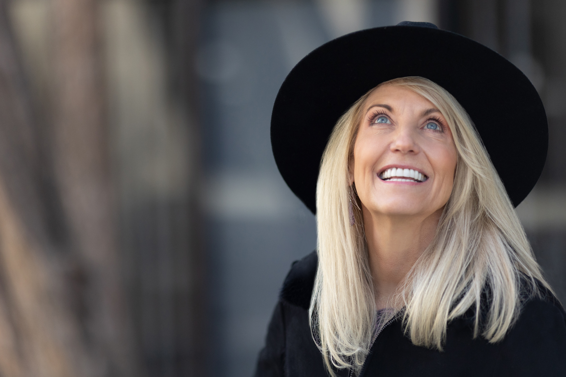 Woman wearing cowboy hat and tailored outfit for dating photo session in Denver.”