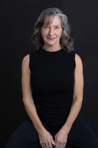 Headshot branding image of a woman in black over 60 years old
