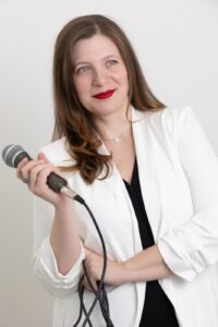 Personal Branding Photo - Smiling woman holding a microphone.