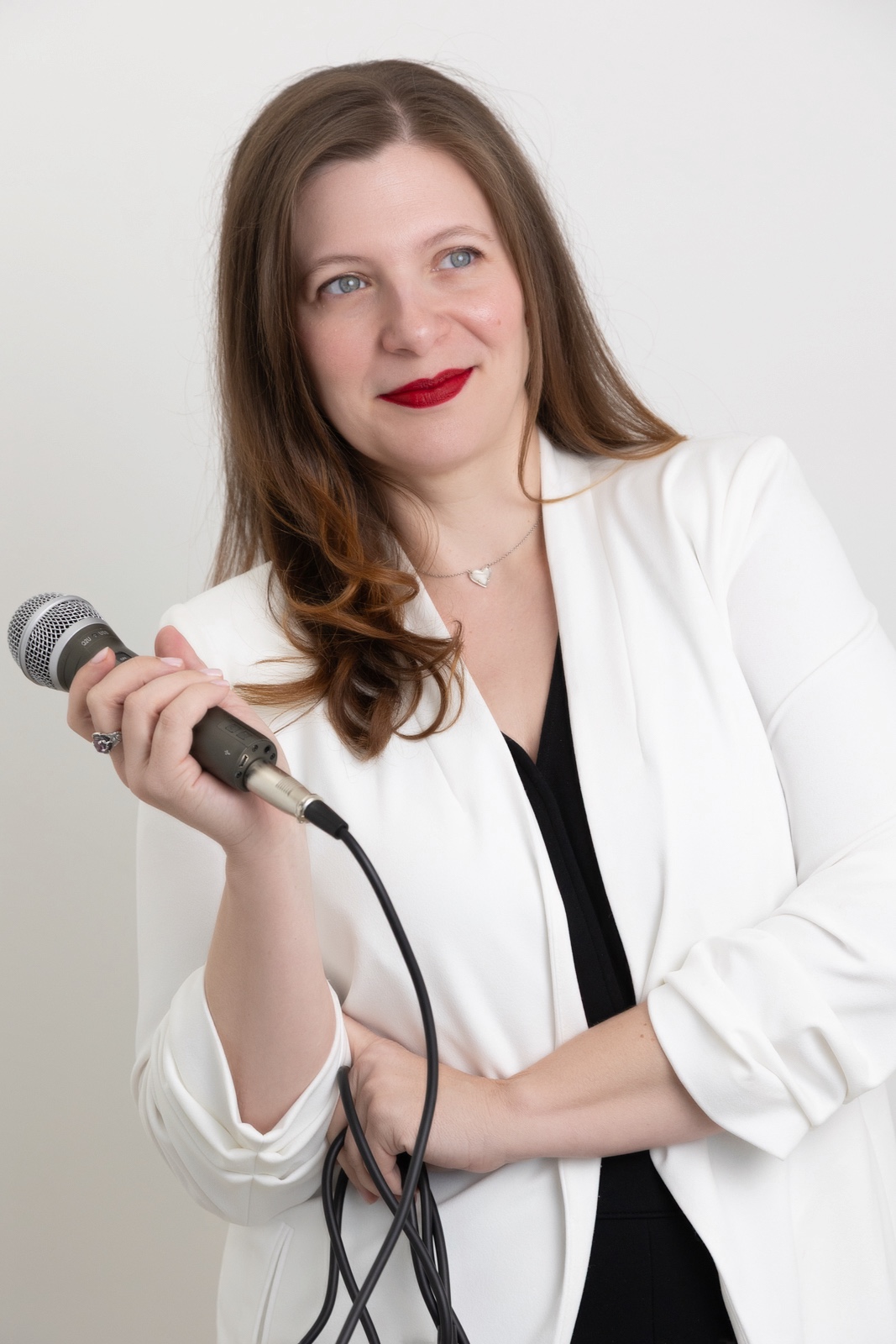 Personal Branding Photo - Smiling woman holding a microphone.