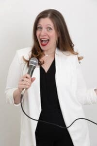 Personal Branding Photograph: Smiling woman holding a microphone