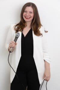 Personal Branding Photo- Smiling speaker holding a microphone.