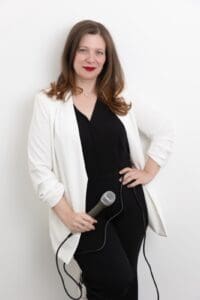 Personal branding speaker photo of a women holding a microphone