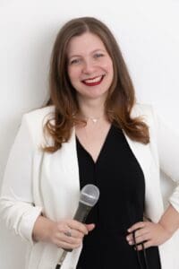 Personal Branding Photo: Smiling woman holding a microphone.